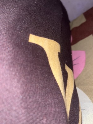 Close-up of dark patterned sheer tights on leg.