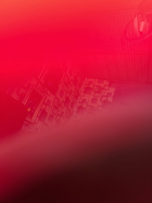 Red-lit bathroom interior with patterned walls and shower.
