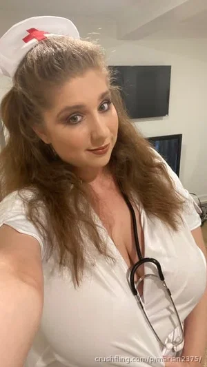 Woman in nurse costume with white cap and stethoscope, indoors.