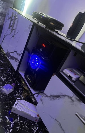Audio equipment setup in marble cabinet with blue lights.