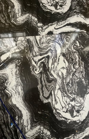 Black and white marble surface with swirling patterns.