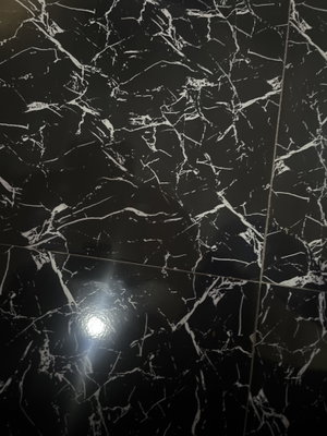 Black marble tiled floor with white veins.