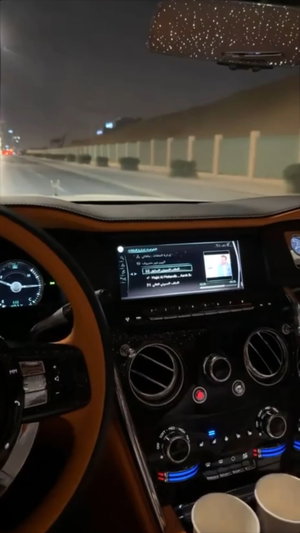 Luxury car interior at night on highway.