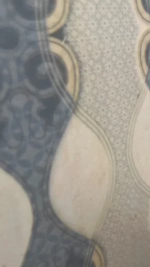 Close-up of patterned fabric with circular designs and textured background.