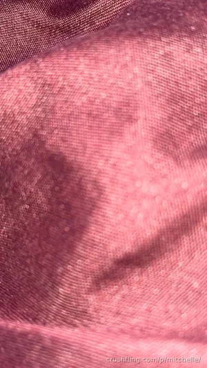 Close-up of pink textured fabric with subtle shimmer.
