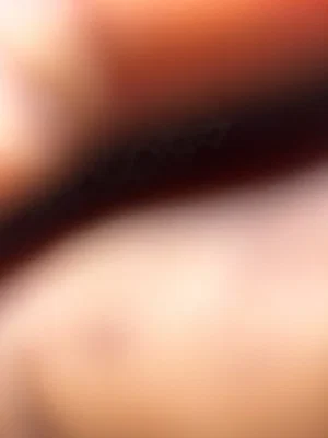 Blurred close-up of skin and dark hair, indistinct features.