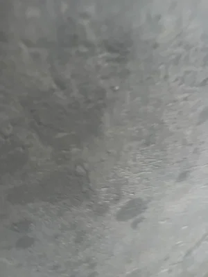 Blurred gray textured surface, no person visible.