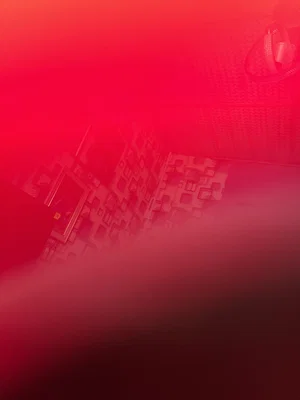 Red-lit elevator interior with patterned walls.