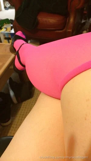 Person in pink underwear and socks, legs visible, sitting indoors.