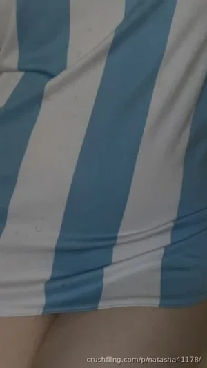 Blue and white striped fabric, possibly bedding, with a beige surface below.