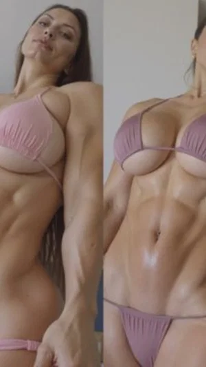 Woman in pink and purple bikinis showing toned physique indoors.
