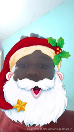 Person with dark skin wearing Santa hat and beard filter, indoors.