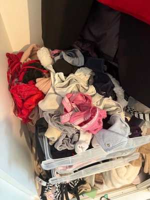 Pile of bras and underwear in a storage bin.