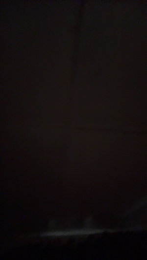 Very dark image with no clear person or details visible.