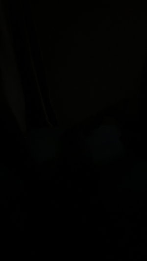 Dark image with no visible person or details.