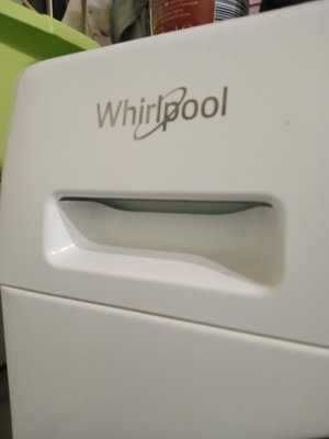 Close-up of white Whirlpool appliance with handle.