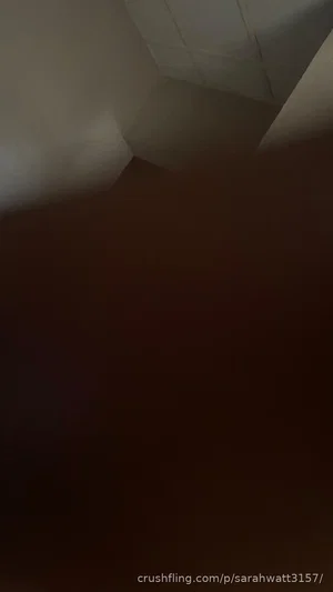 Dark, blurry image with indistinct shapes, possibly a corner of a room.