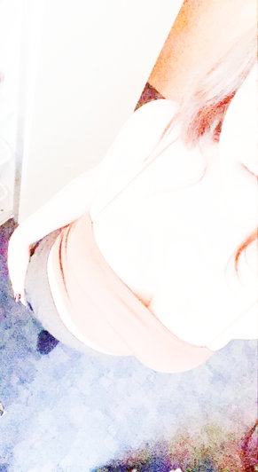 Overexposed close-up of a person's arm and shoulder, possibly in a bedroom setting.