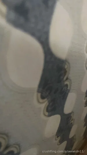 Abstract patterned surface with dark and light shapes, possibly fabric or wallpaper.