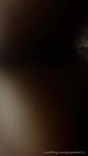 Blurred close-up of skin tone in dark setting, indistinct features.