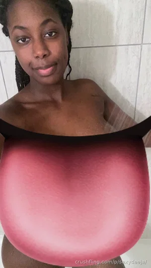 Woman with braided hair in bathroom, topless above waist, red object covering lower body.