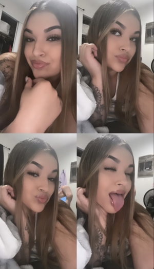 Woman with long brown hair taking selfies in bedroom.