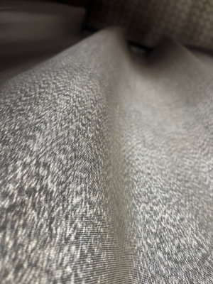 Close-up of light gray textured fabric.