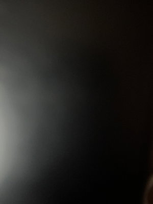 Dark, blurry image with no clear subject or details visible.