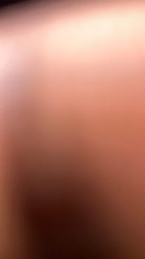 Blurred close-up of skin tone, no distinct features visible.