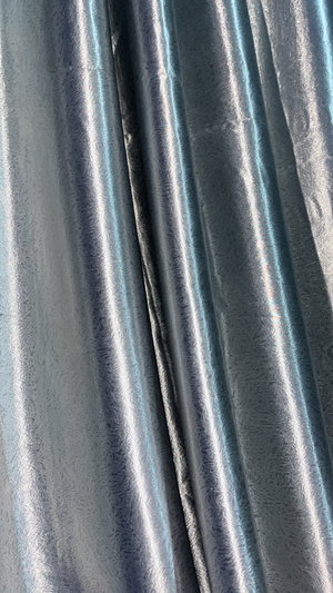 Shiny metallic blue and silver fabric folds.
