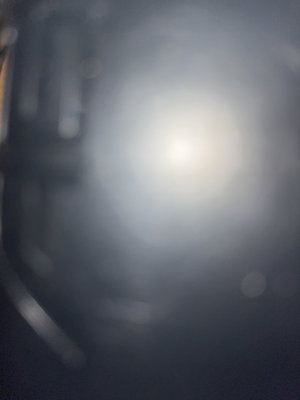 Blurry bright light with dark shapes.
