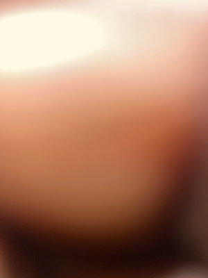 Blurred close-up of skin tones, possibly a person, indistinct setting.