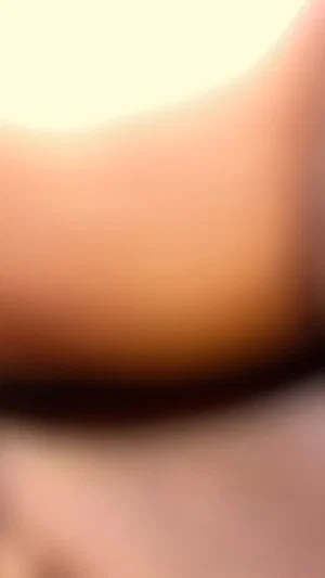 Blurred close-up of skin, possibly torso or leg, indistinct setting.