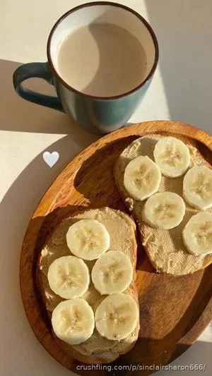 Breakfast scene with banana-topped toast on wooden plate and mug of coffee.