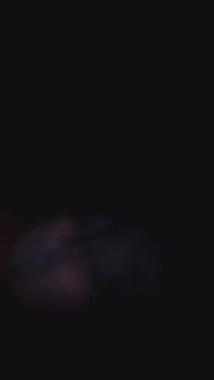 Blurry dark image, indistinct shapes, no clear person or setting visible.