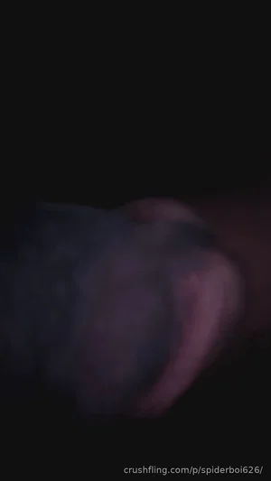 Blurry close-up of a dark, indistinct shape in low light.