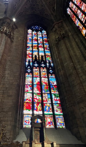 Stained glass window in gothic cathedral interior.
