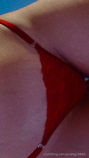 Woman in red lace lingerie, close-up of torso and hip area.