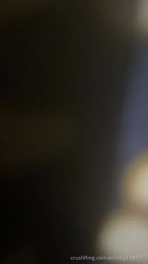 Blurred image with indistinct shapes and lights, no clear person or setting visible.
