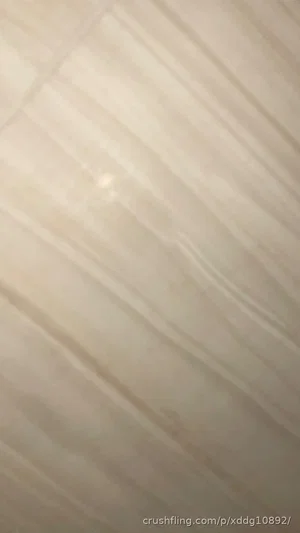 Close-up of light-colored wooden surface with diagonal grain pattern.