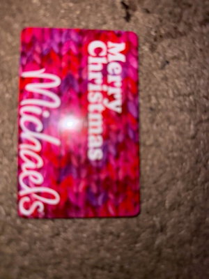 Pink gift card with text on carpet.