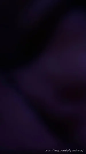 Dark, blurry image with indistinct shapes and no clear person or setting.