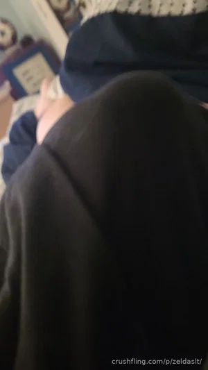 Person in dark clothing, partial view of arm and torso, indoor setting.